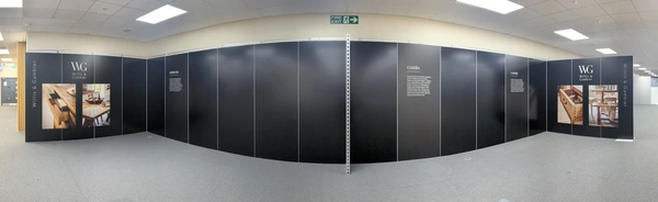 a long wall of black panels with some being printed