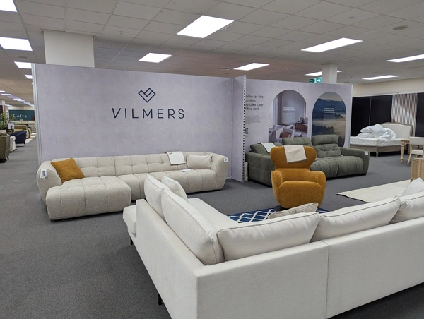 an 8m wide back wall has three sofas and a chair sat in front