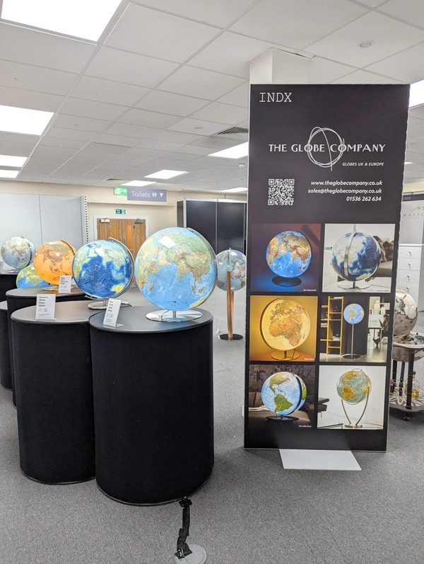 6 globes are displayed on the left hand side with a freestanding modular frame with a print on the right hand side